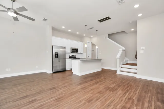 a view of kitchen with cabinets and wooden floor