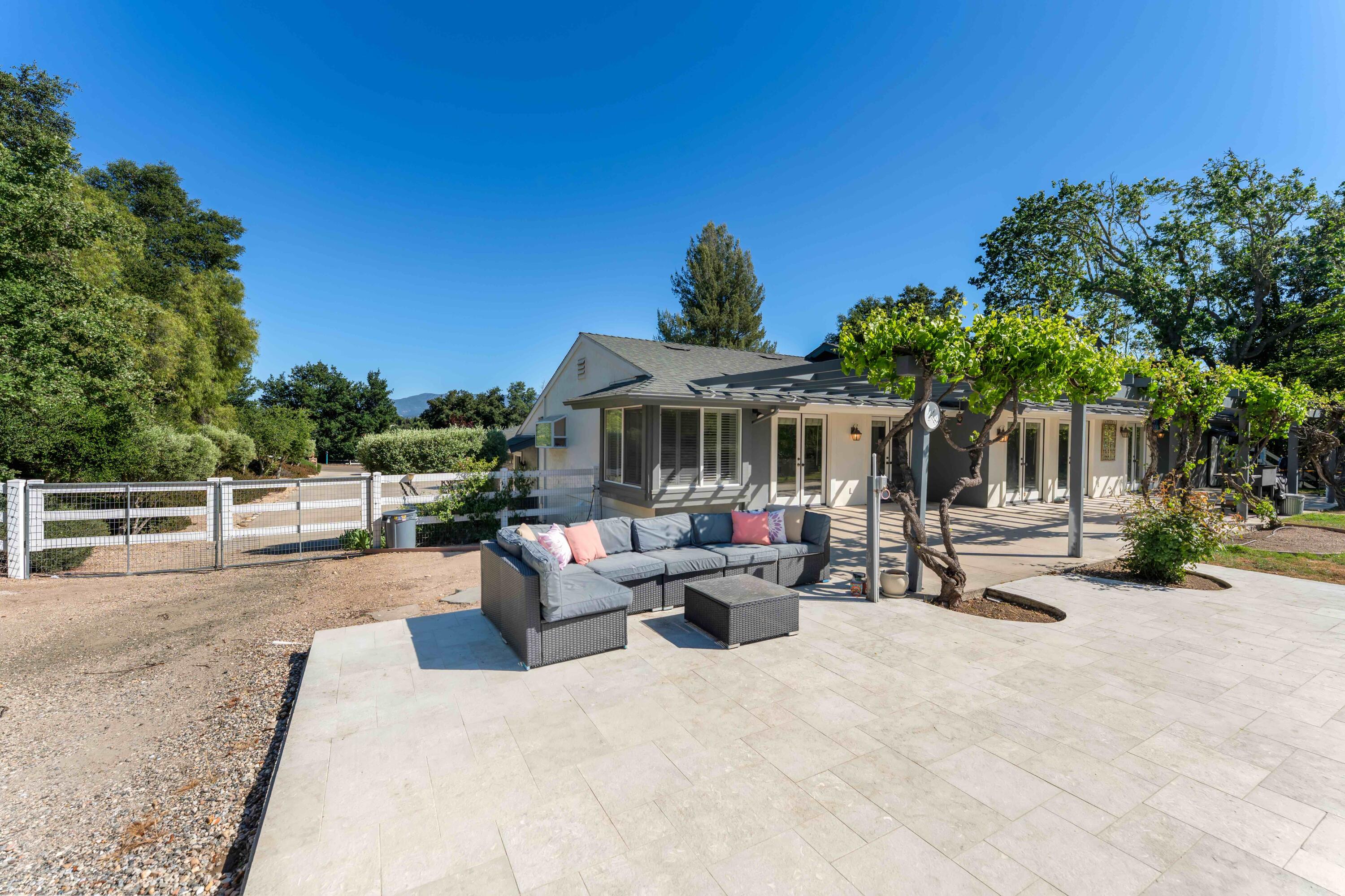 2667 Quail Valley Road Solvang, CA 93463 - Photo 32 of 62 a view of a patio with couches and table and chairs with wooden fence