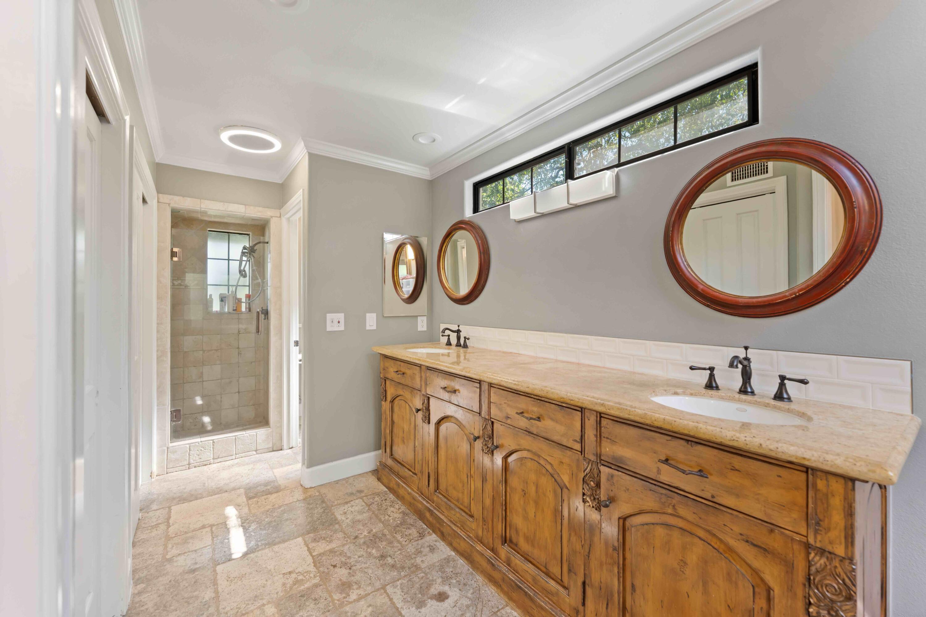 2667 Quail Valley Road Solvang, CA 93463 - Photo 39 of 62 a bathroom with a granite countertop double vanity sink and a mirror