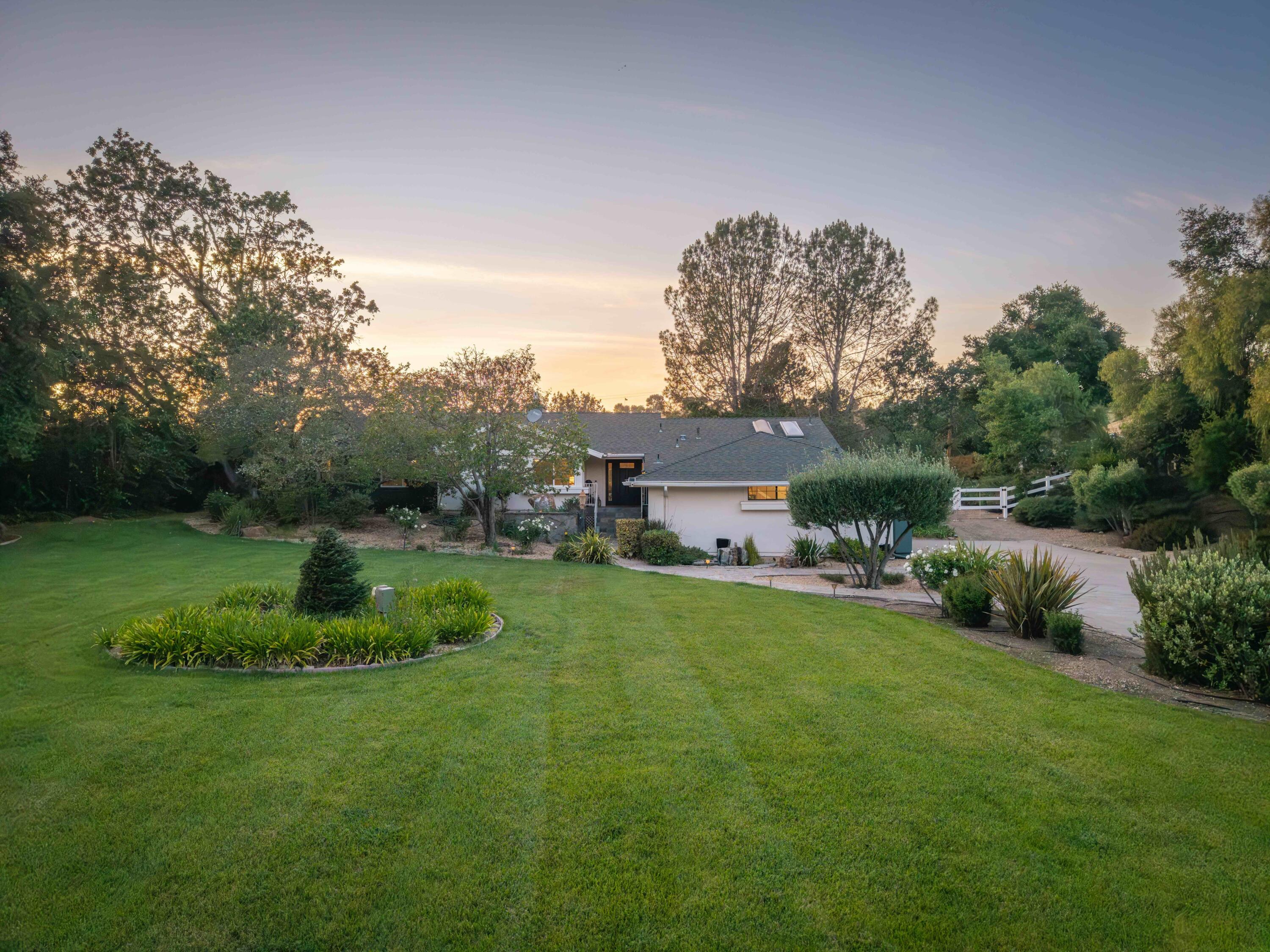 2667 Quail Valley Road Solvang, CA 93463 - Photo 54 of 62 a view of a house with a big yard potted plants and large trees