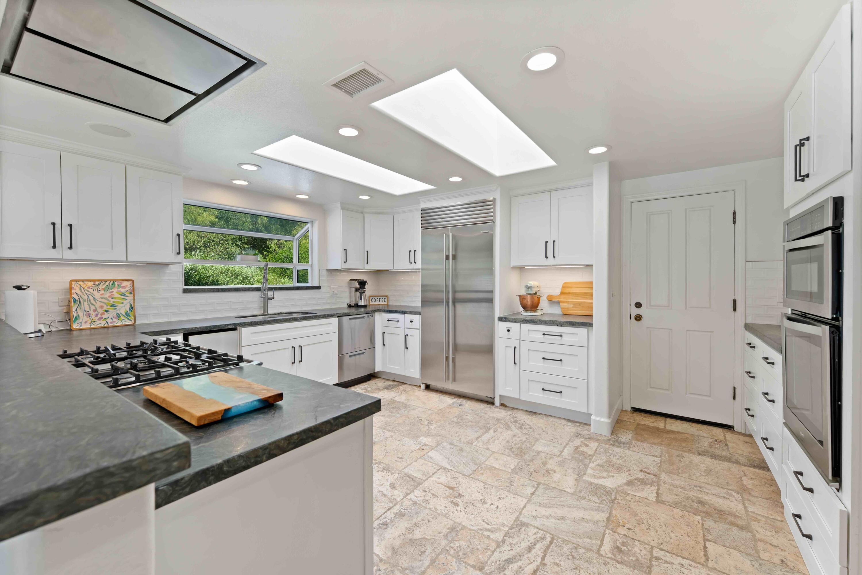 2667 Quail Valley Road Solvang, CA 93463 - Photo 6 of 62 a kitchen with white cabinets and appliances