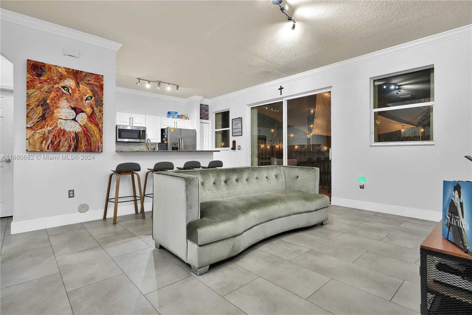 12922 Southwest 135th Street Miami, FL 33186 - Photo 11 of 62 a living room with furniture and a flat screen tv