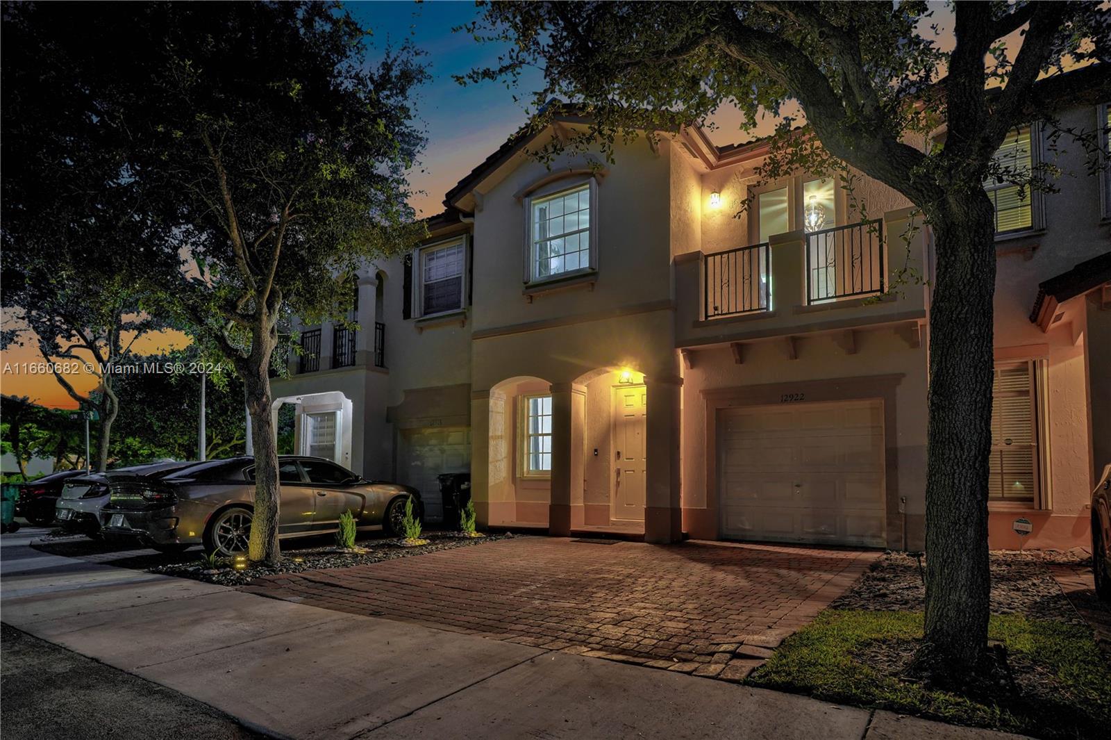 12922 Southwest 135th Street Miami, FL 33186 - Photo 3 of 62 a view of a building with a cars park side of a road