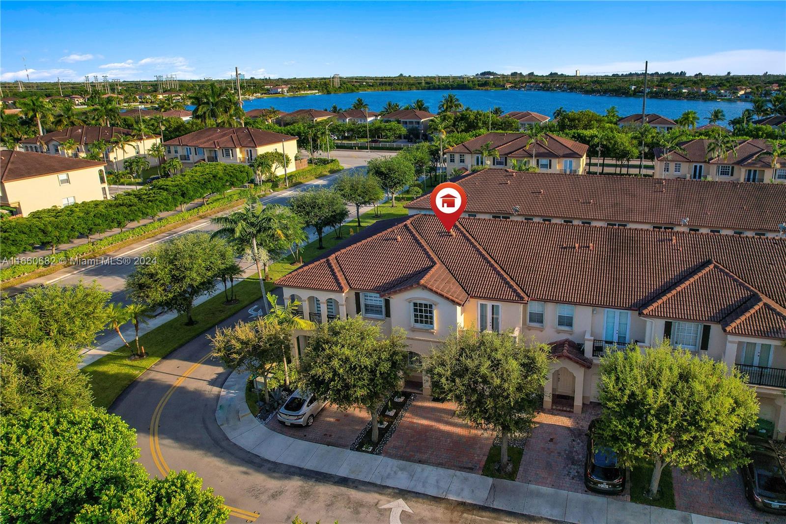 12922 Southwest 135th Street Miami, FL 33186 - Photo 4 of 62 an aerial view of a house with a garden and lake view