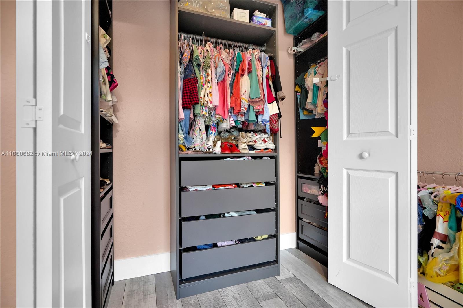 12922 Southwest 135th Street Miami, FL 33186 - Photo 41 of 62 a view of walk in closet with clothes and shoes