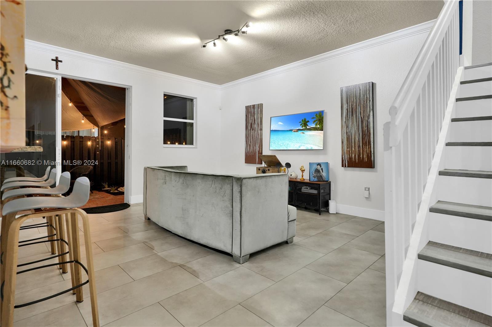12922 Southwest 135th Street Miami, FL 33186 - Photo 10 of 62 a living room with furniture and a flat screen tv