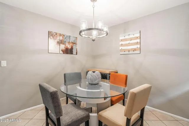 a kitchen with a dining table chairs and stove