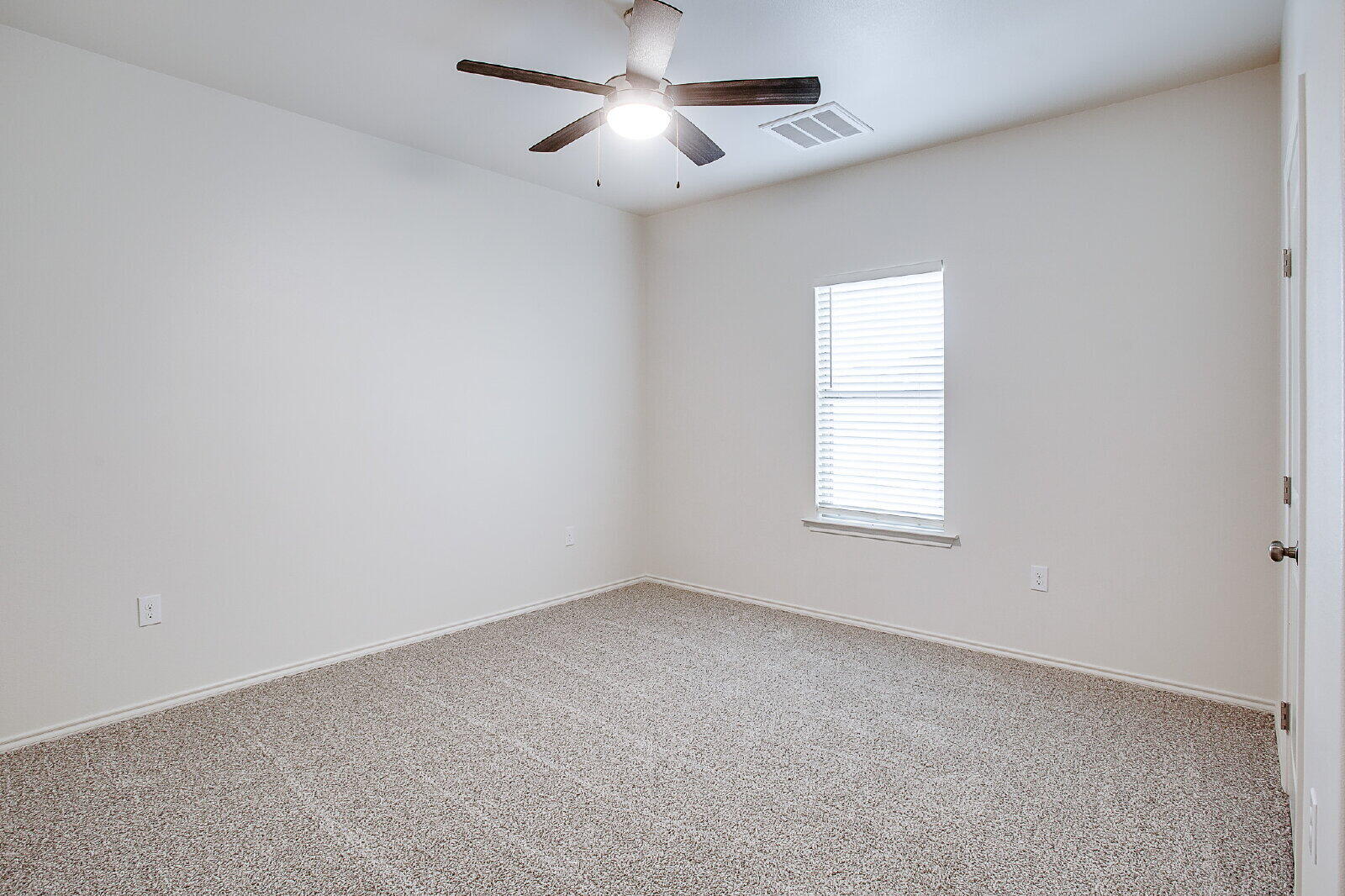 5520 121st Street, Unit B Lubbock, TX 79424 - Photo 13 of 17 an empty room with a window and a ceiling fan