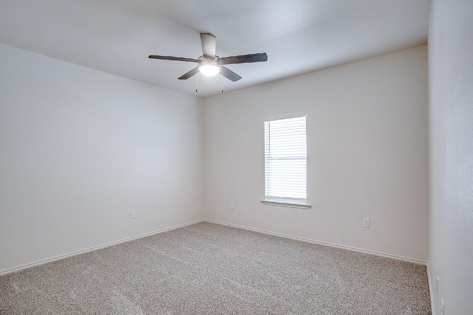 5520 121st Street, Unit B Lubbock, TX 79424 - Photo 15 of 17 an empty room with windows and fan