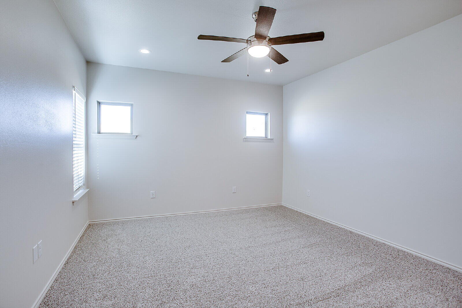 5520 121st Street, Unit B Lubbock, TX 79424 - Photo 9 of 17 an empty room with a window and a fan