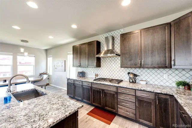 a kitchen with a sink stove and cabinets