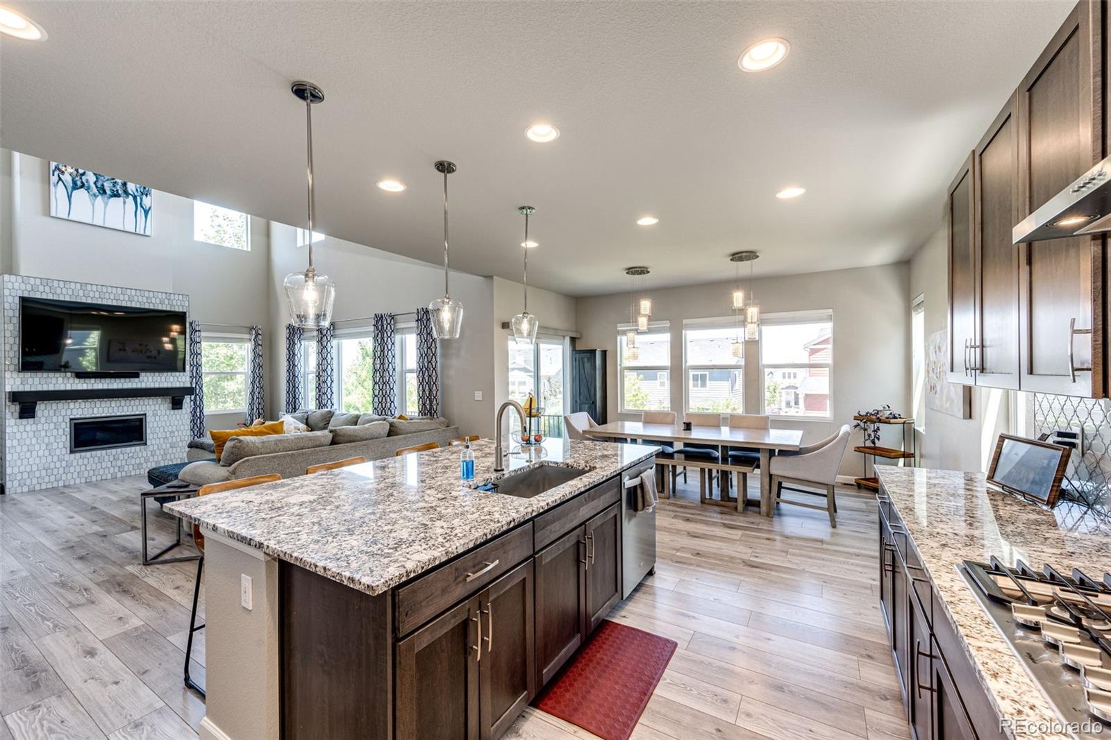 5086 Basalt Ridge Circle Castle Rock, CO 80108 - Photo 13 of 46 a kitchen with granite countertop a stove and white cabinets