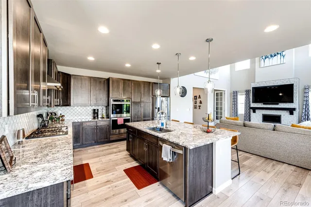 a large kitchen with stainless steel appliances kitchen island granite countertop a large counter top and stove