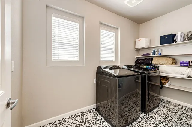 a kitchen with a refrigerator and a stove top oven