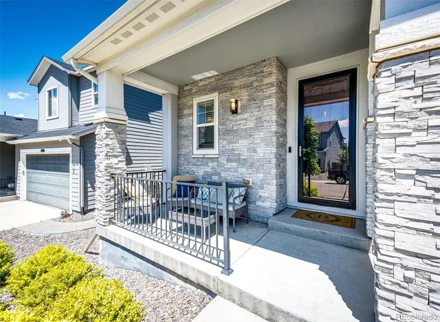 a balcony with furniture and a potted plant