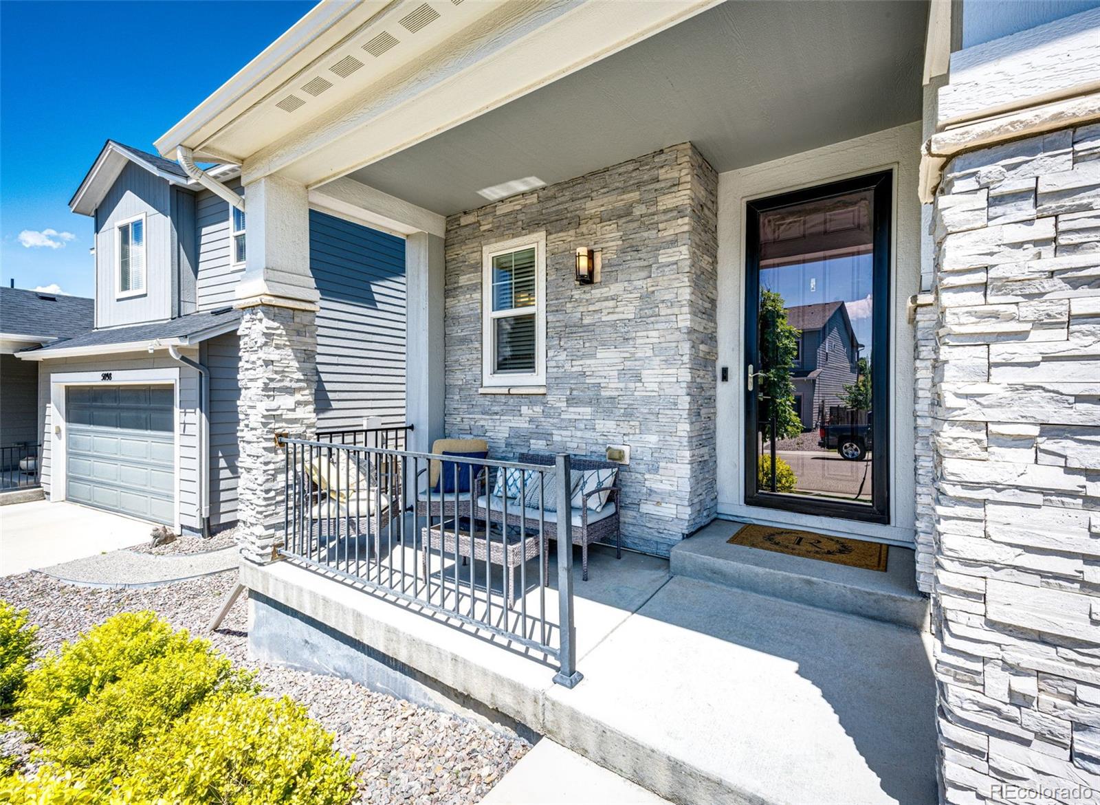 5086 Basalt Ridge Circle Castle Rock, CO 80108 - Photo 2 of 46 a balcony with furniture and a potted plant