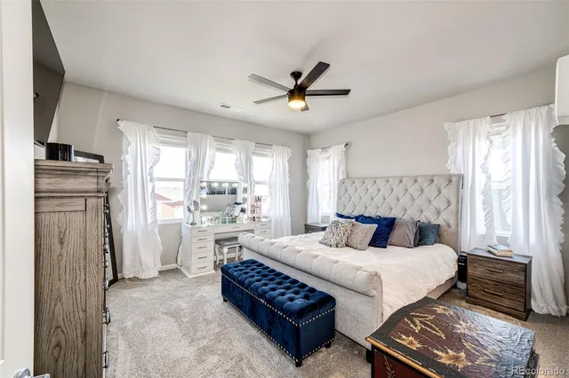 a bedroom with a bed and a refrigerator