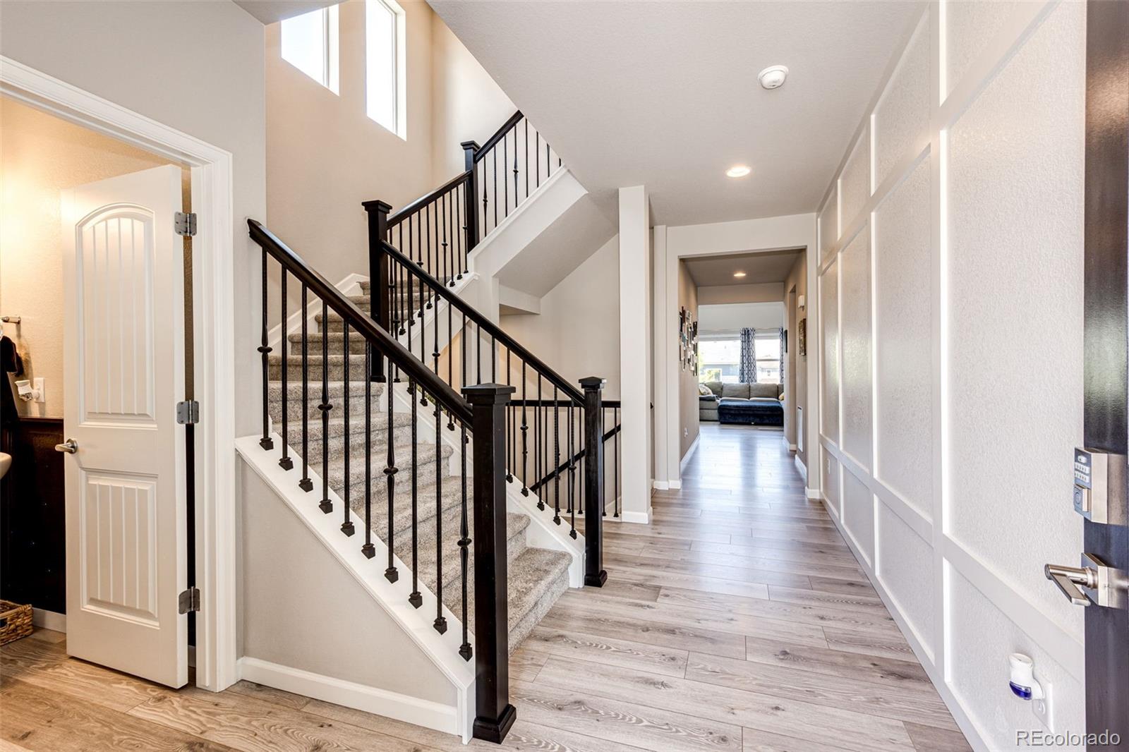 5086 Basalt Ridge Circle Castle Rock, CO 80108 - Photo 3 of 46 a view of a hallway with the wooden floor and entryway