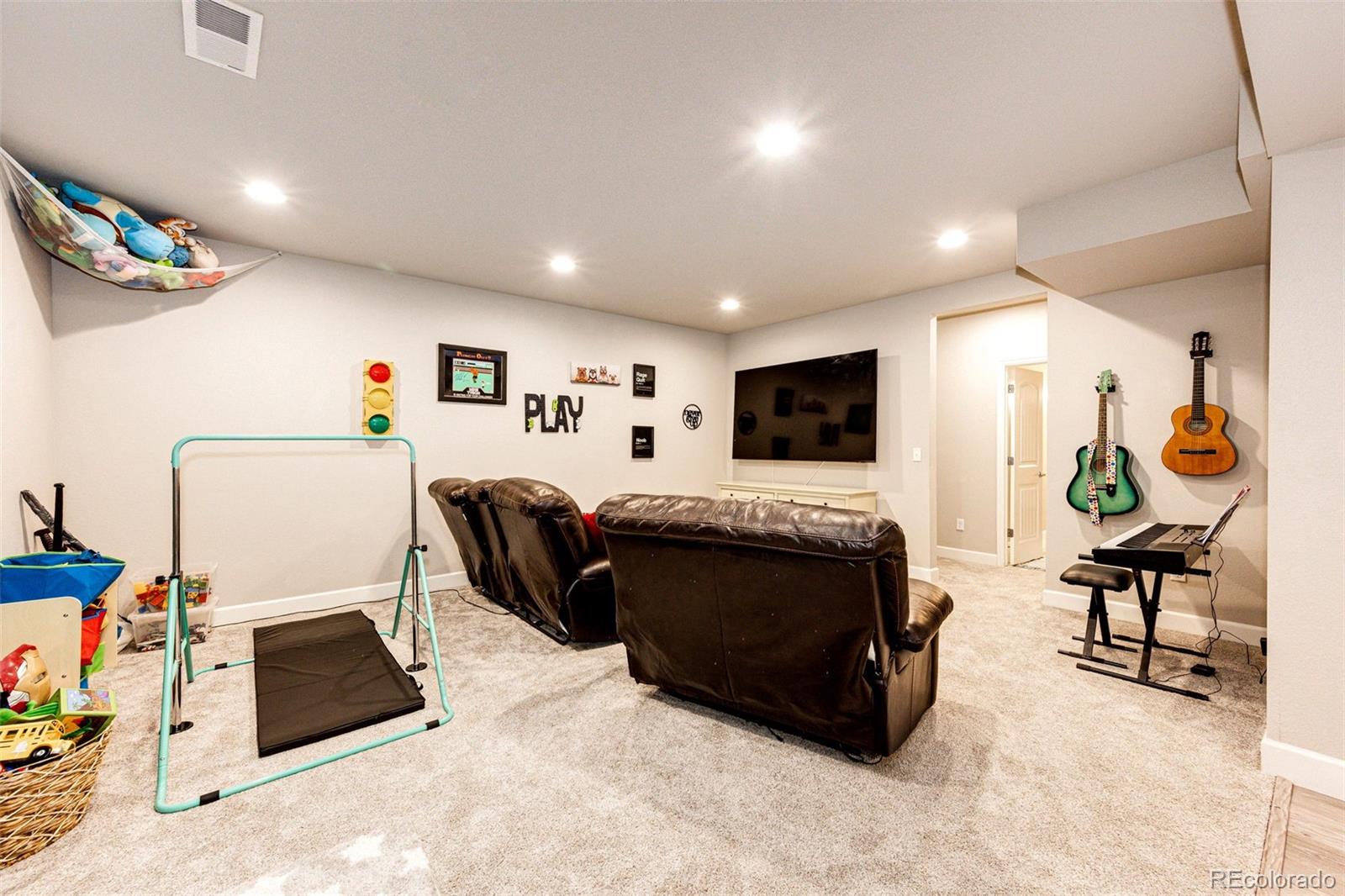 5086 Basalt Ridge Circle Castle Rock, CO 80108 - Photo 33 of 46 a living room with furniture and a flat screen tv