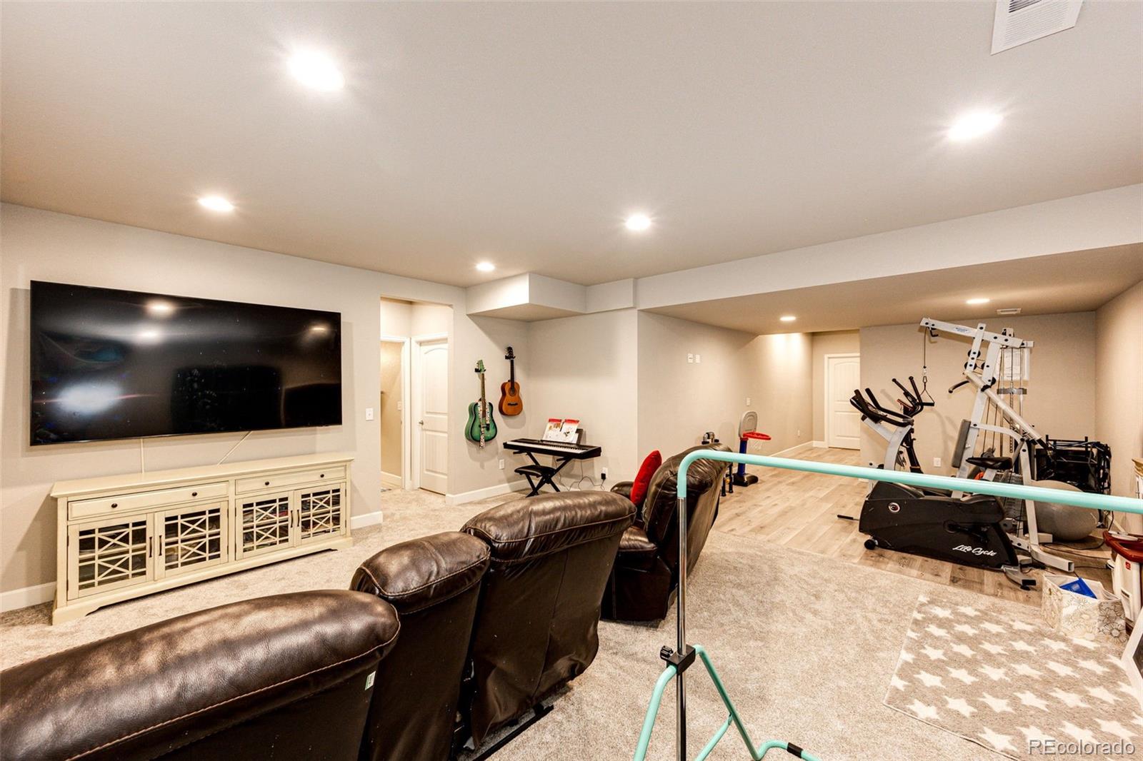 5086 Basalt Ridge Circle Castle Rock, CO 80108 - Photo 34 of 46 a living room with furniture and a flat screen tv