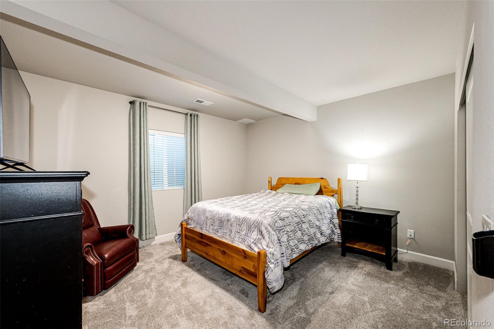 5086 Basalt Ridge Circle Castle Rock, CO 80108 - Photo 35 of 46 a bedroom with a bed and wooden floor