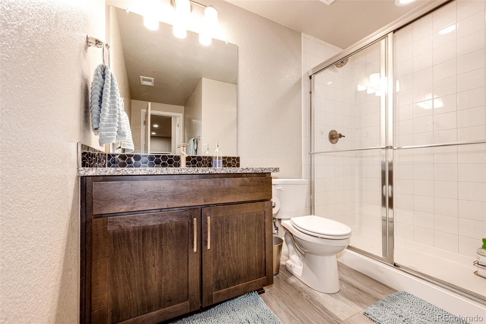 5086 Basalt Ridge Circle Castle Rock, CO 80108 - Photo 36 of 46 a bathroom with a sink toilet and shower