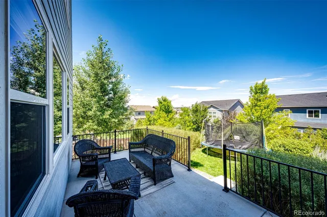a view of balcony with furniture and garden