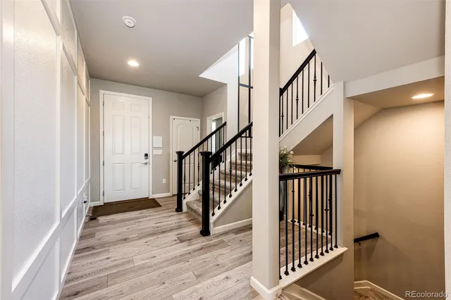 a view of entryway with wooden floor and stairs