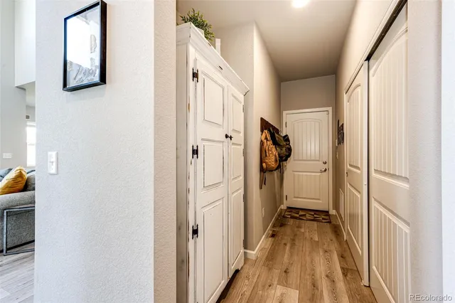a view of a hallway with wooden floor and staircase