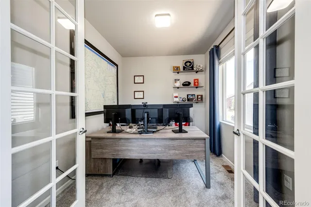 a room with furniture a window and a view of kitchen