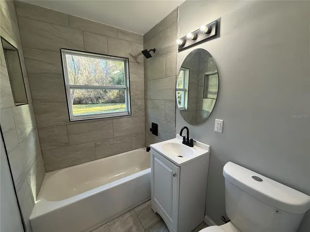 a bathroom with a toilet sink and bathtub