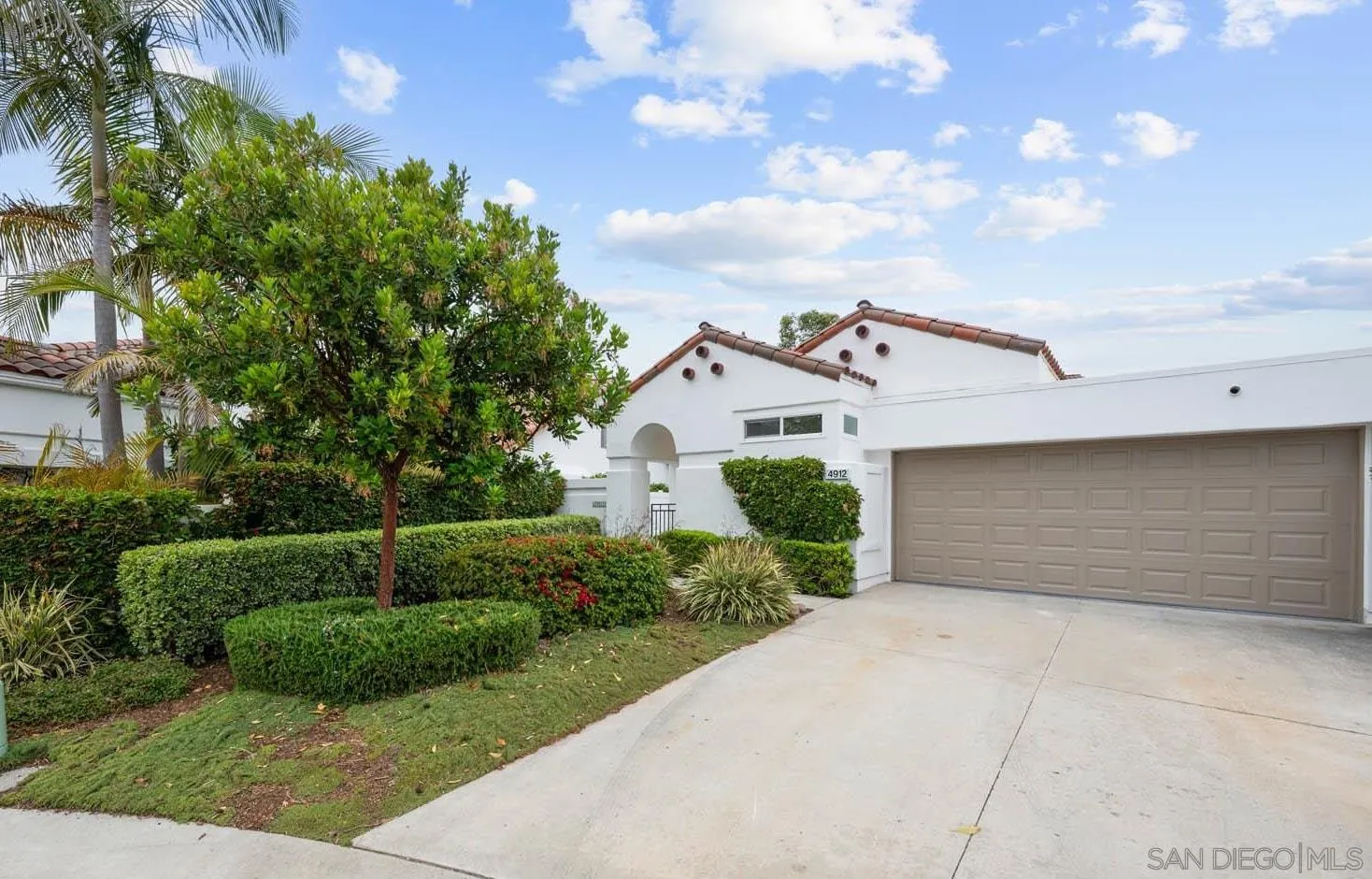 4912 Keos Way Oceanside, CA 92056 - Photo 1 of 1 a view of a white house with a yard and potted plants
