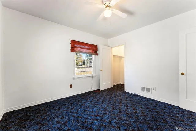 a very nice looking room with a ceiling fan and a window