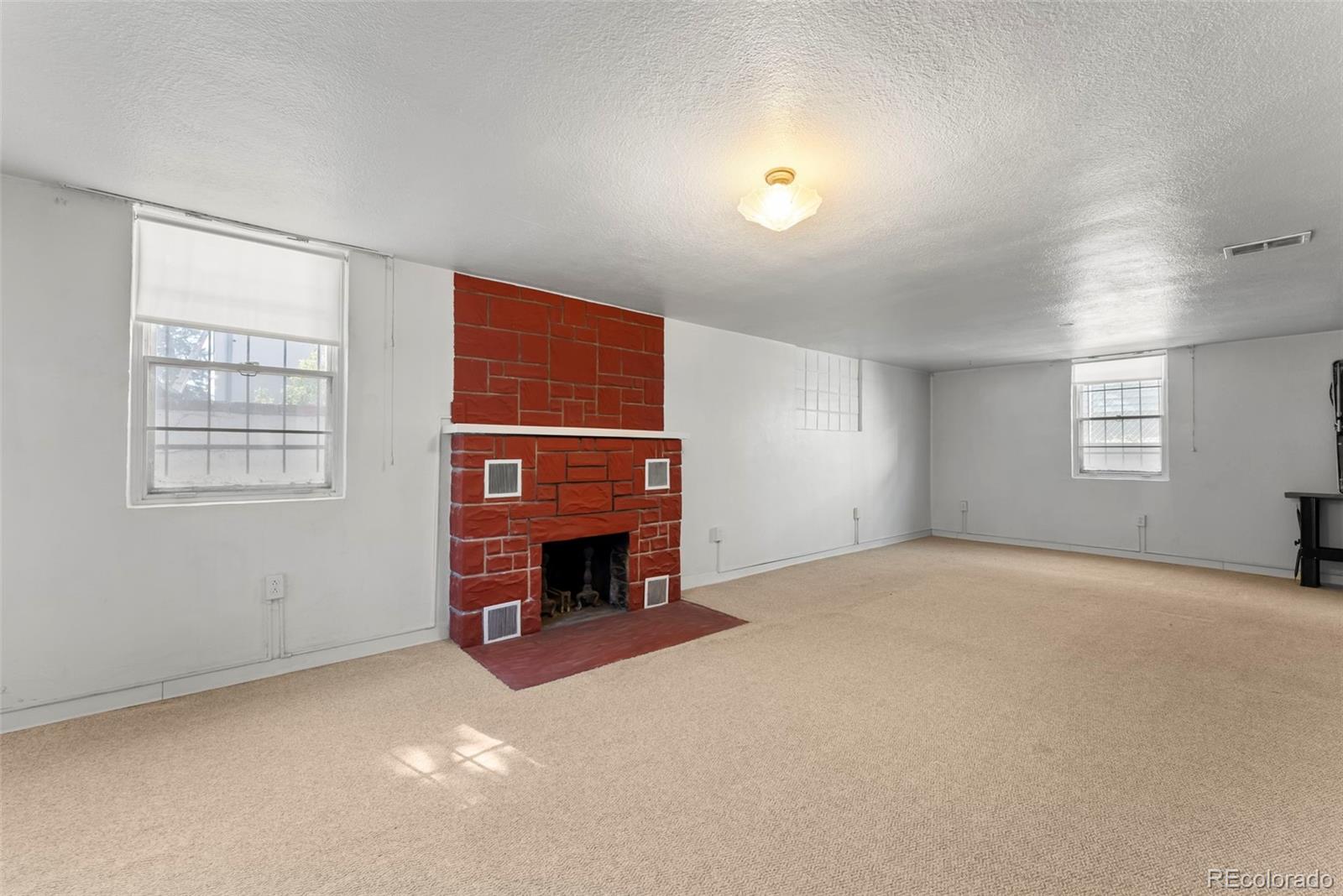 632 North Foote Avenue Colorado Springs, CO 80909 - Photo 16 of 30 an empty room with windows fireplace and windows