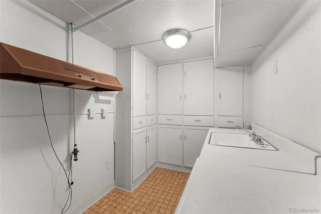 a utility room with cabinets washer and dryer