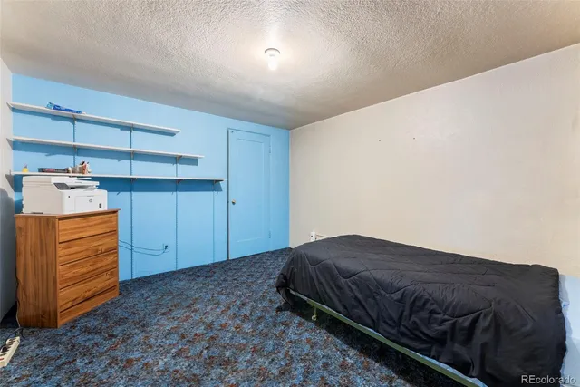 a bedroom with a bed and cabinets
