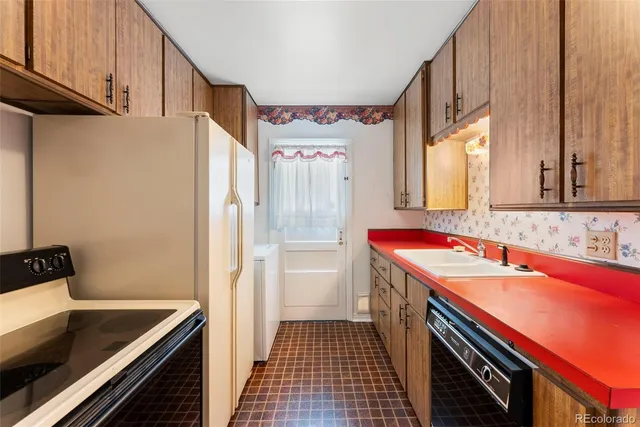 a kitchen with a sink stove and refrigerator