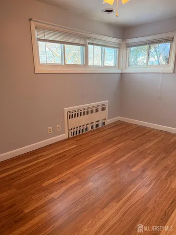 a view of a room with wooden floor and windows