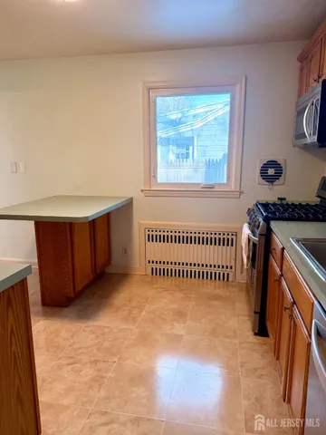 a view of a room with wooden floor and windows