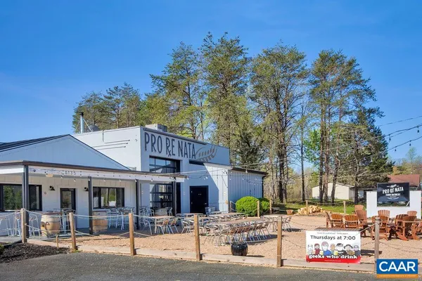 a front view of a building with trees