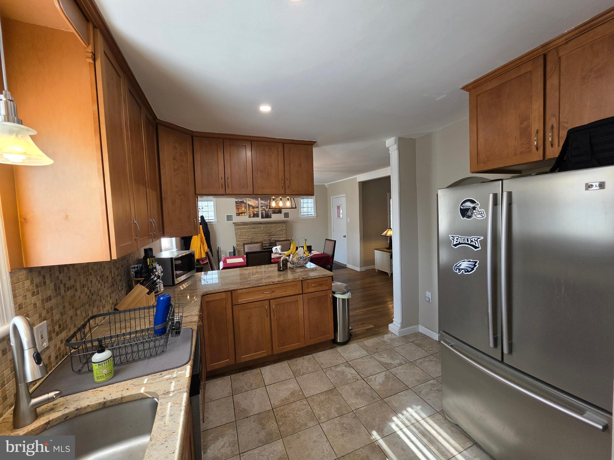 142 New Road Horsham, PA 19044 - Photo 9 of 38 a kitchen with stainless steel appliances granite countertop a refrigerator and a stove top oven