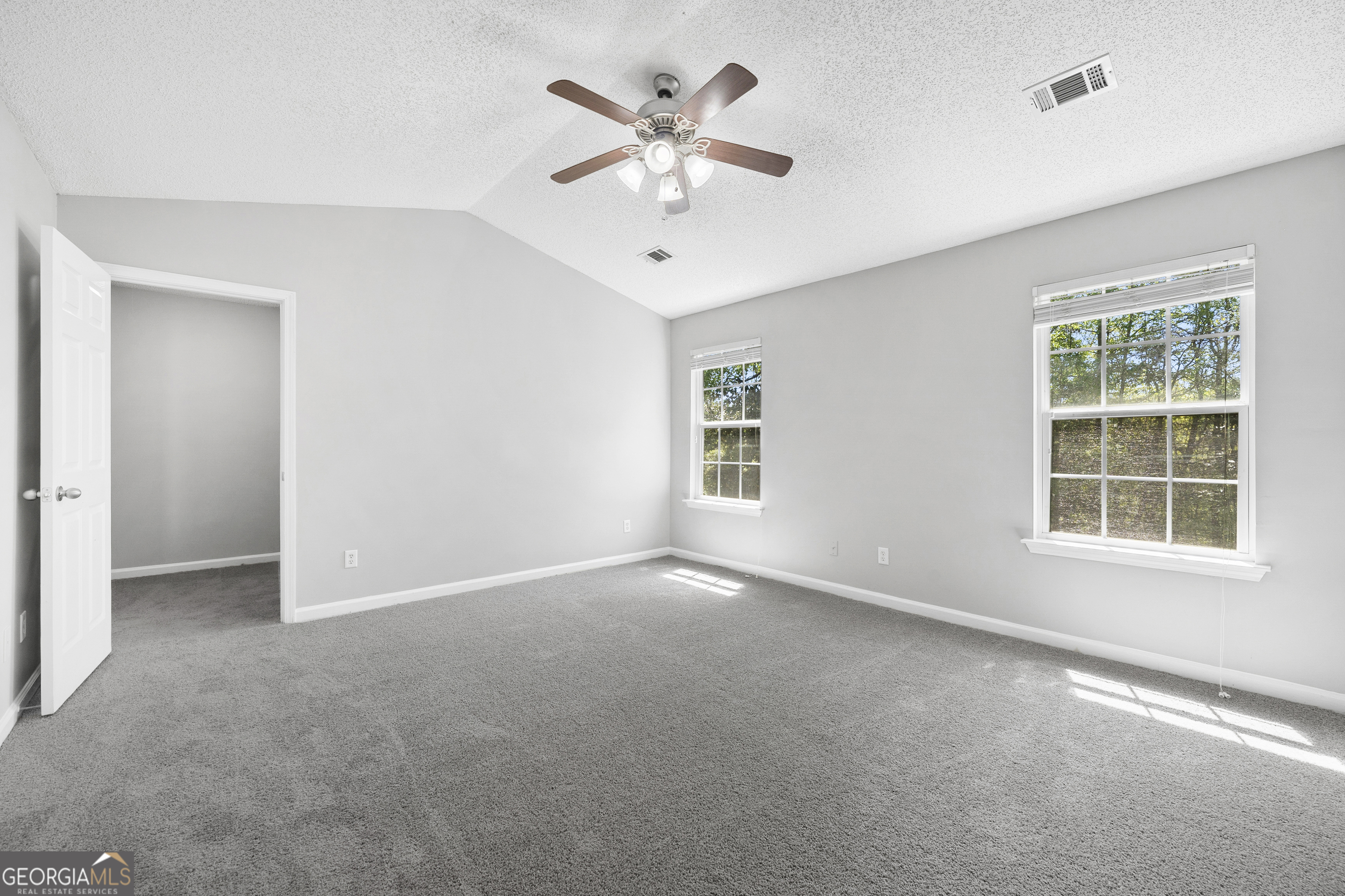 1883 Simmons Lane Hampton, GA 30228 - Photo 13 of 28 an empty room with windows and ceiling fan