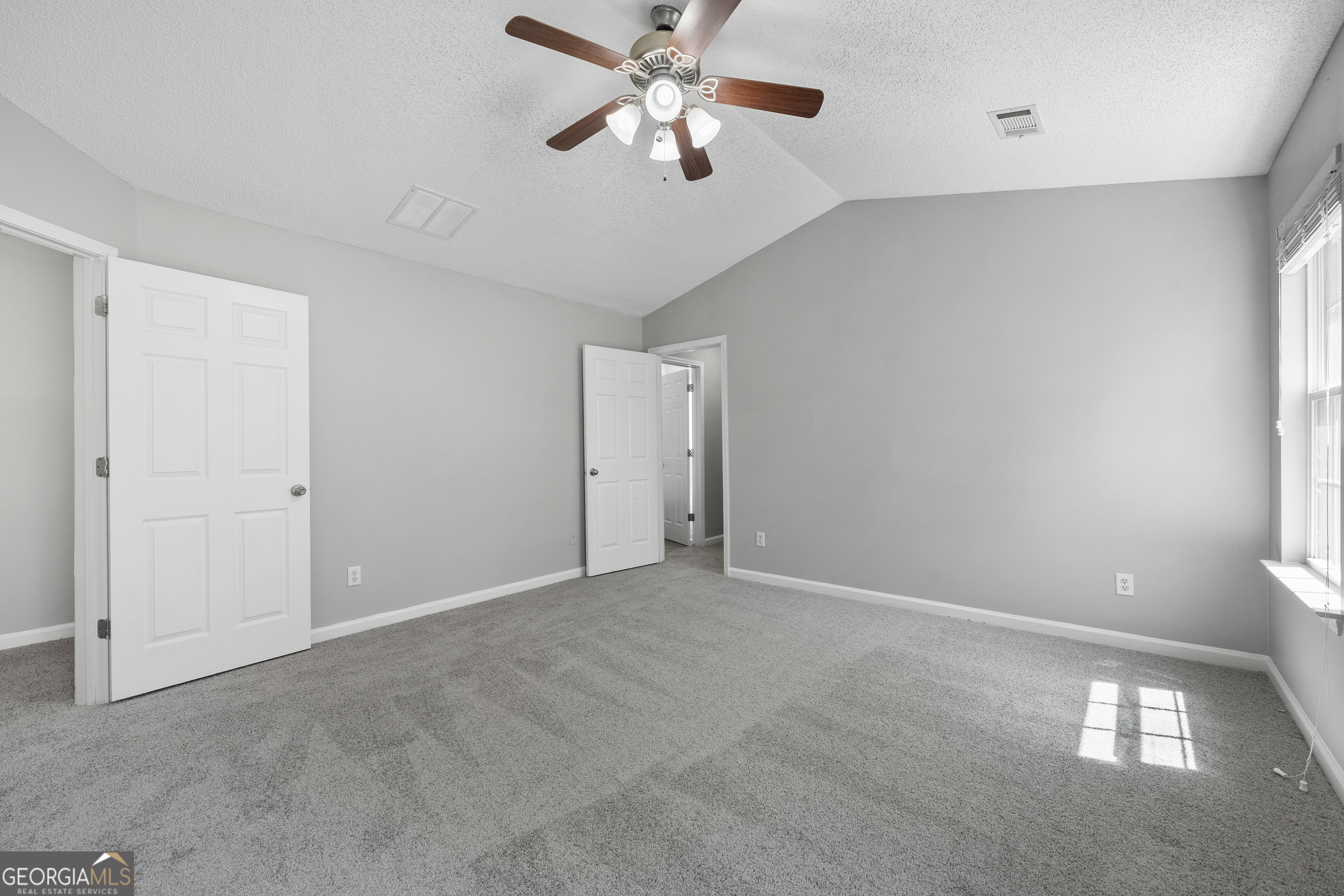1883 Simmons Lane Hampton, GA 30228 - Photo 14 of 28 an empty room with closet and a chandelier fan