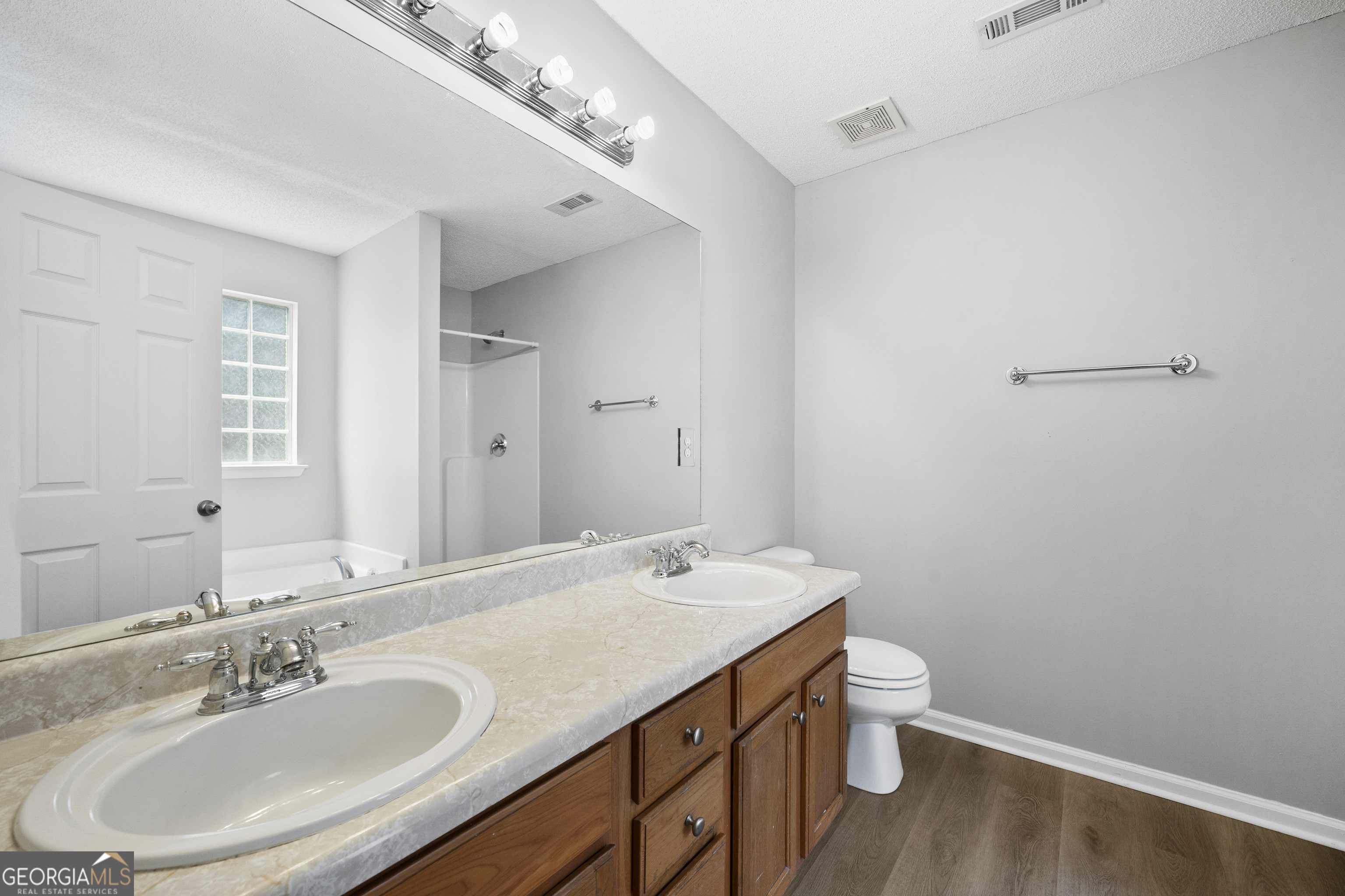 1883 Simmons Lane Hampton, GA 30228 - Photo 17 of 28 a bathroom with a sink a toilet and a mirror