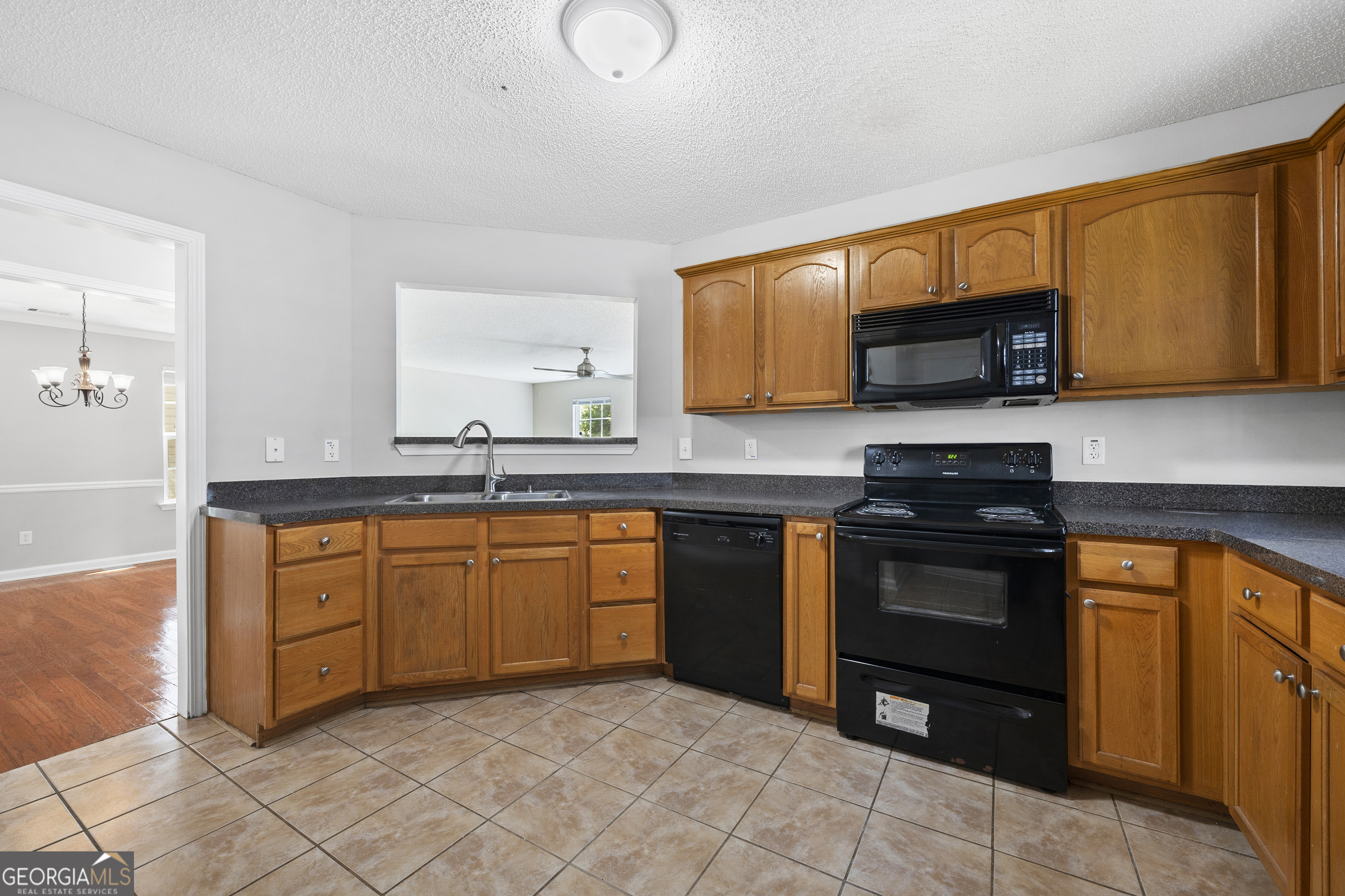 1883 Simmons Lane Hampton, GA 30228 - Photo 3 of 28 a kitchen with stainless steel appliances granite countertop a stove top oven a sink dishwasher and a microwave oven on the blue kitchen countertops