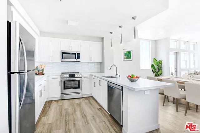 a kitchen with a stove a sink and a refrigerator