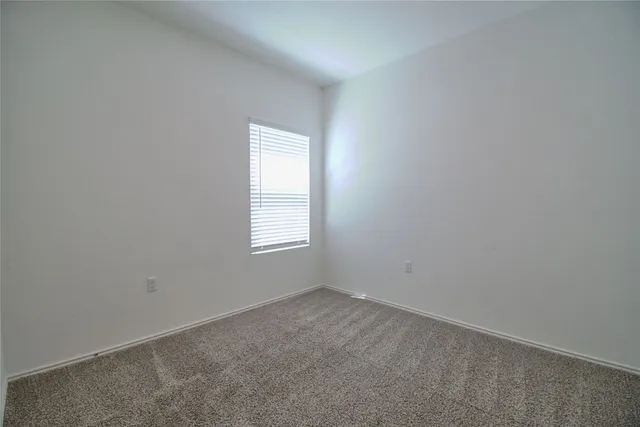 a view of an empty room with closet area