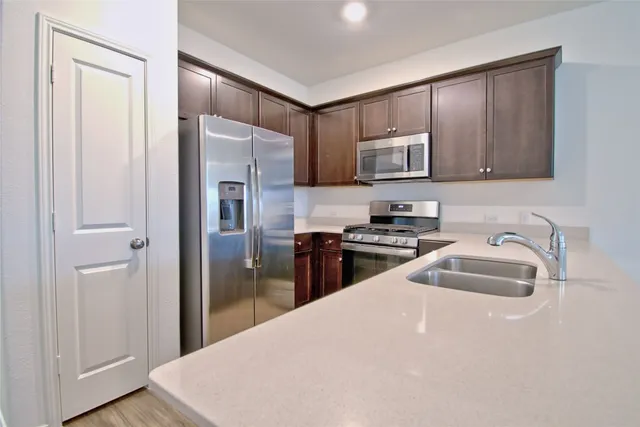 a kitchen with stainless steel appliances and wooden cabinets