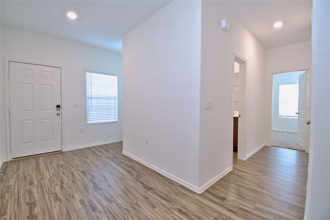 2233 Forgetmenot Lane Pflugerville, TX 78660 - Photo 5 of 28 an empty room with wooden floor & windows