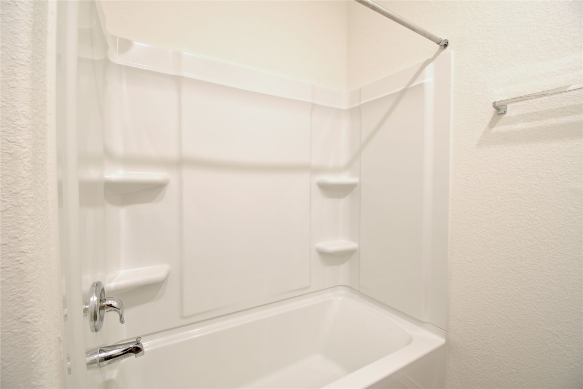 2233 Forgetmenot Lane Pflugerville, TX 78660 - Photo 9 of 28 a bathroom with a bathtub